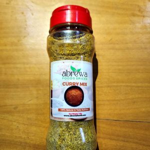 A transparent bottle of curry blend with a red cover