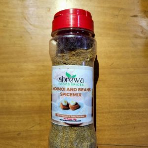 A transparent bottle with a red cap containing a blend of dried tomatoes, bell peppers, and ginger.